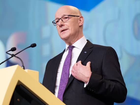 John Swinney speaking from a lectern