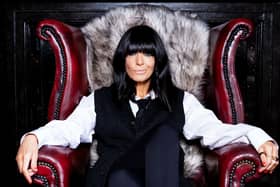 Claudia Winkleman sitting in a chair