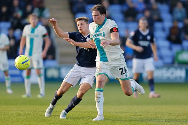 George Lloyd of Shrewsbury Town battles with Logan Dobbs of Gillingham