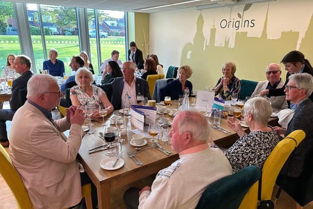Caption for photo 3625: Some of the visitors in the Origins Restaurant setting.