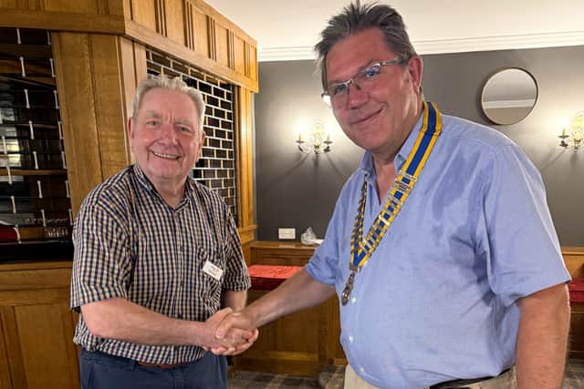 Paul Serrell-Cooke (right) receives the presidential chain of office from outgoing president Tom Hunt.
