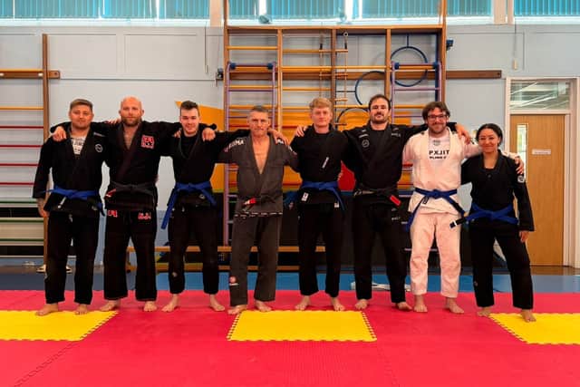 Left to right: Jack Robbins (blue belt), Tom Morris (black belt), Josh Alderson (blue belt), Simon Pearce (black belt), James Moss (blue belt), Owain Williams (black belt), Craig Coleman (blue belt), Melissa Davies (blue belt)