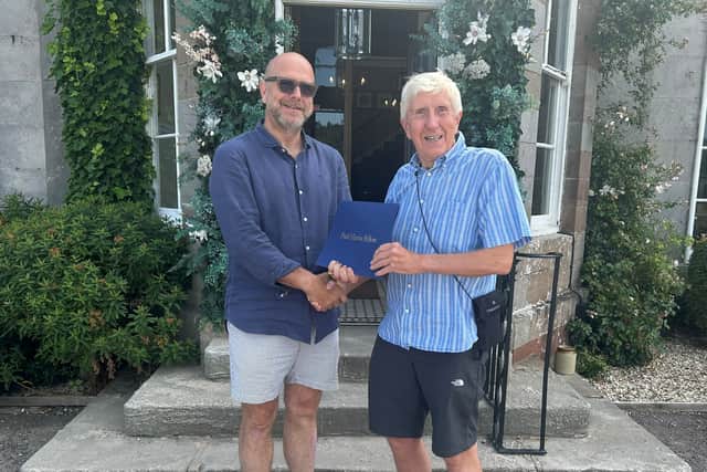 Sean Evans (left) receives the Paul Harris Fellowship Award from Borderland president, Brian Ashton