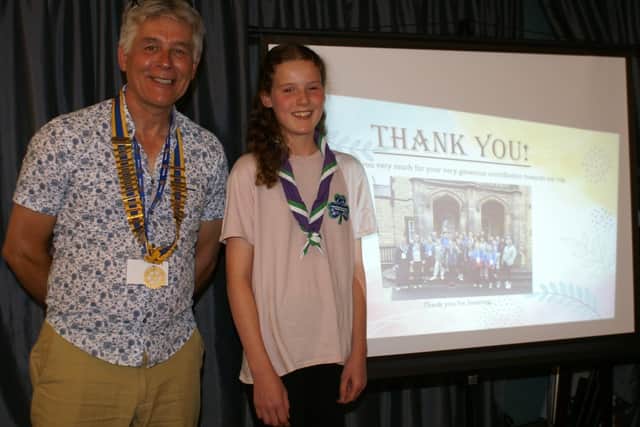 Rotarian Johnathan Callwood with Lucy next to her screen talk