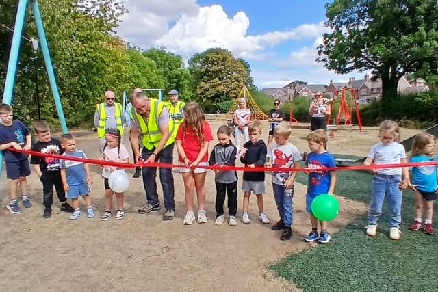 Councillor Duncan Fletcher and children cut the ribbon to open Pontesbury play area