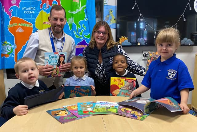 Headteacher Mark Gibbons and Managing Director of book sponsor J&PR. Kirsty Smallman. with reception pupils Mckenzie Hamilton, Raine-Elizabeth Hook, Utibeabasi Effiong-Uko and Gracie Martin
