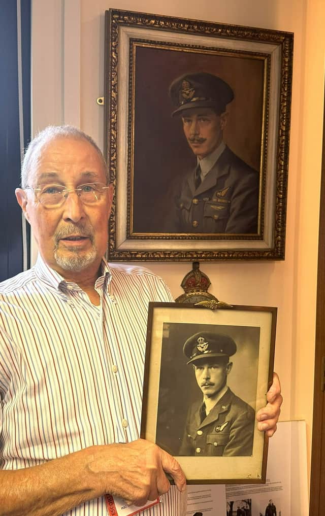 Chris Bryan-Smith stands in front of the portrait holding his photograph of Martin