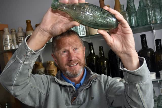 John Thompson examining a typical collectors bottle