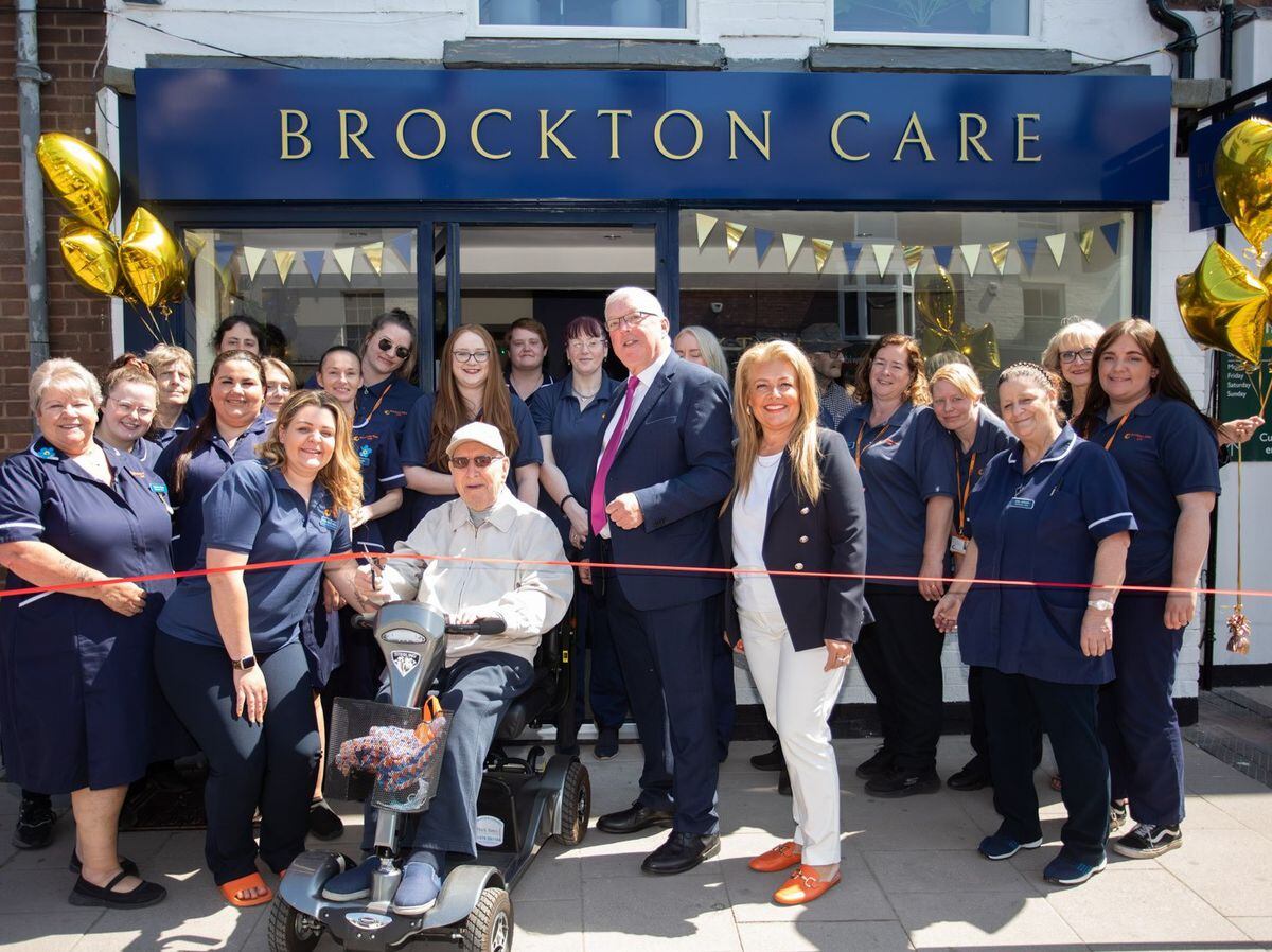 Newport West Councillor Peter Scott and Brockton Care business owner Tracy Willetts-Perrins, centre, celebrate the opening of the new unit with the Brockton Care Ltd team