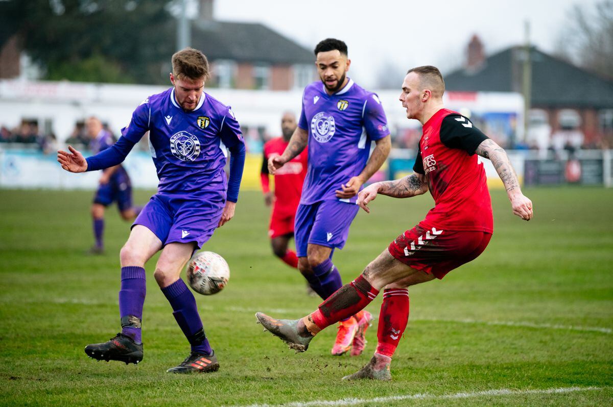 Whitchurch Alport F.C (red) vs Congleton Town (Purple) in the forth round of the FA Vase at Whitchurch. In Picture: 11 Alex Hughes on (Whitchurch on the ball).