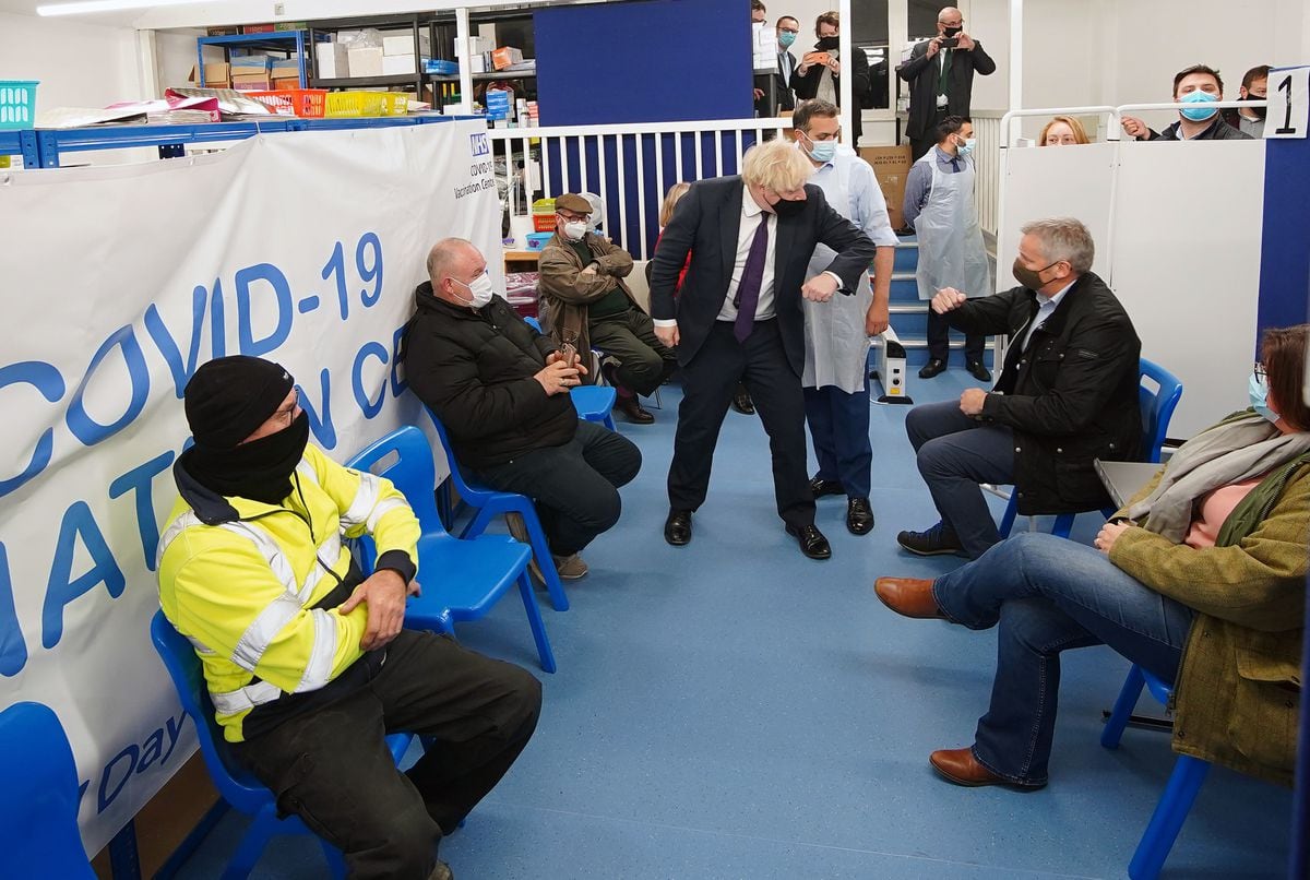 Prime Minister Boris Johnson meets people waiting to receive their Covid-19 booster vaccine. Photo: Peter Byrne/PA Wire