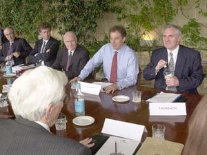 Tony Blair and his Irish counterpart Bertie Ahern, right, with Northern Ireland secretary John Reid at a table with Ulster politicians at Weston Park