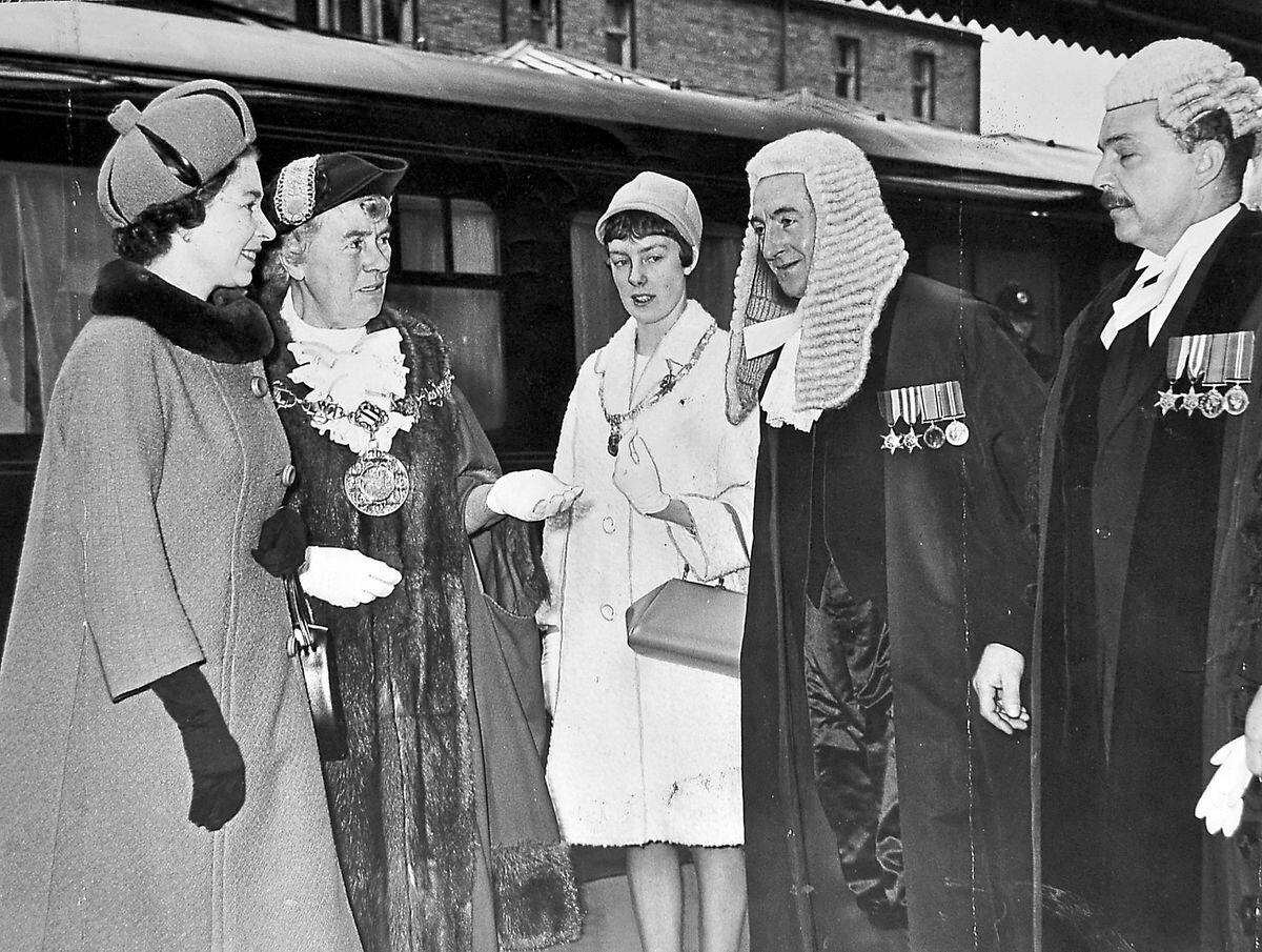 The Queen arriving at Shrewsbury for a royal visit on March 17, 1967. The caption pasted on this print reads: 'The recorder of Shrewsbury, Mr D P Draycott, is presented to the Queen by the mayor, Alderman Mrs E M Lancaster, on the royal visit to Shrewsbury today. Second left is the mayoress, Miss Pat Lancaster'