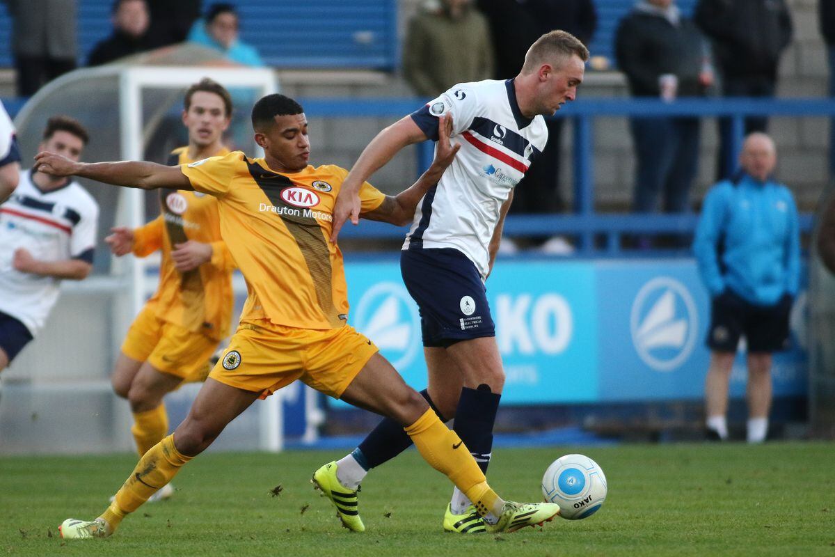 Jonathan Royle holds off Marcus Marshall during the Vanarama National League North game between AFC Telford United and Boston United at the New Bucks Head