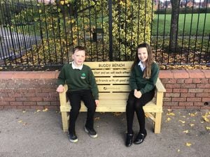Seth and Kadence with Market Drayton Junior School's new 'buddy bench' 