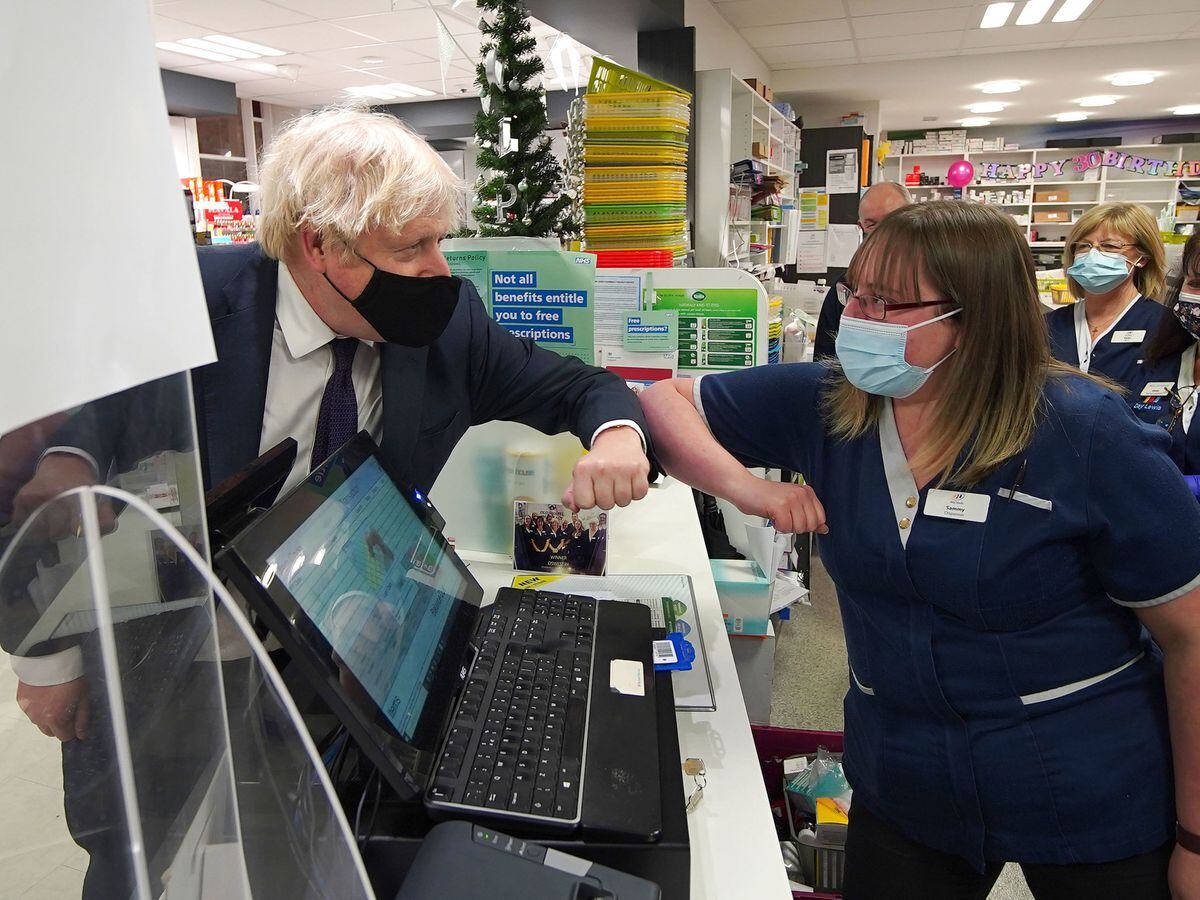 Prime Minister Boris Johnson meets staff at the Oswestry pharmacy during his visit. Photo: Peter Byrne/PA Wire.
