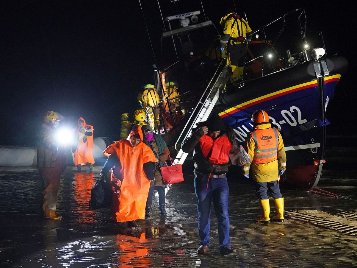 A group of people thought to be migrants are brought in to Dungeness, Kent, after being rescued by the RNLI lifeboat following a small boat incident in the Channel