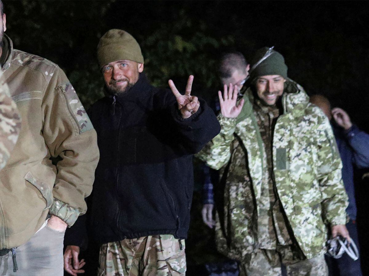 Ukrainian soldiers, who were released in a prisoner exchange between Russia and Ukraine, smile close to Chernihiv, Ukraine