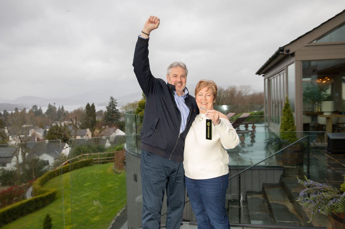 Catherine Carwardine and her husband outside their new house