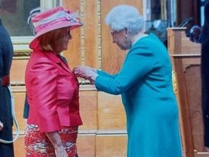 The Queen presents Carol with her MBE 