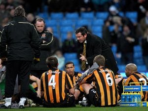 Hull City manager Phil Brown gives his team talk, on the pitch during the half time interval.