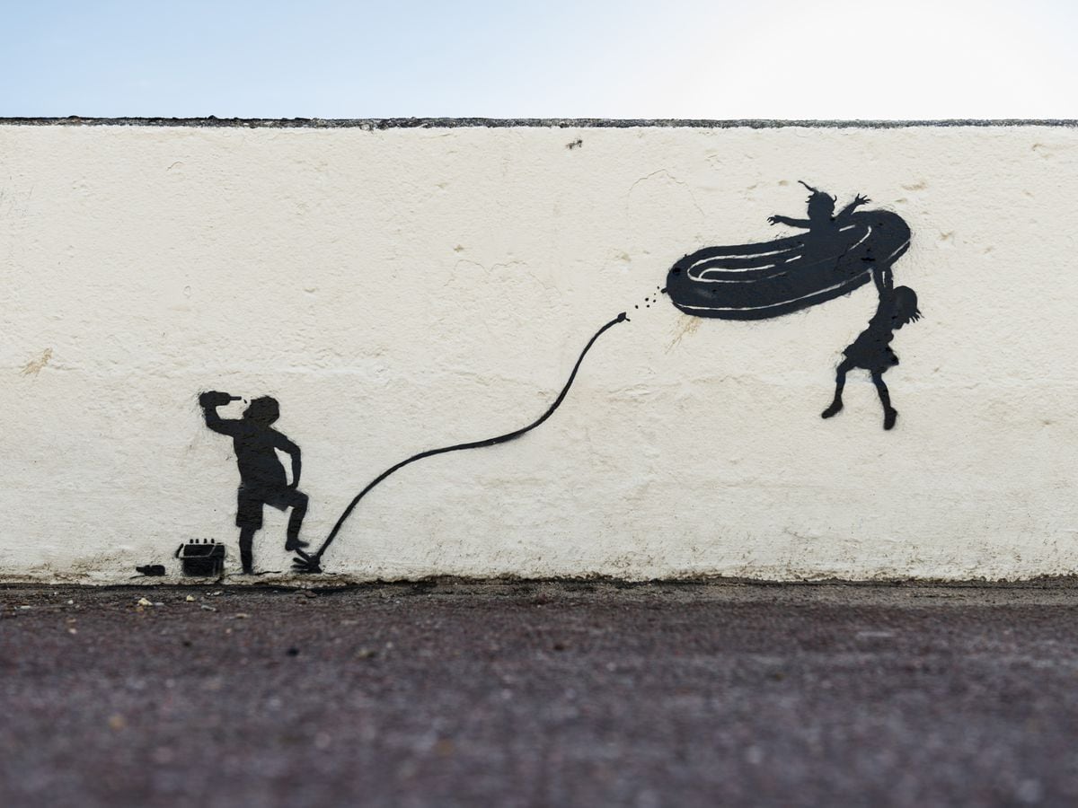 Banksy's artwork on a promenade wall in Gorleston in Norfolk depicts children being propelled into the air on an overinflated dinghy