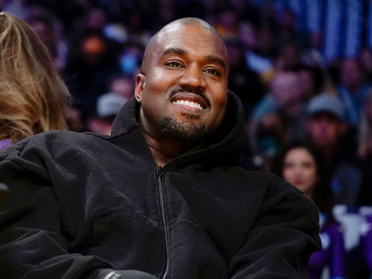 Kanye West, known as Ye, watches the first half of an NBA basketball game