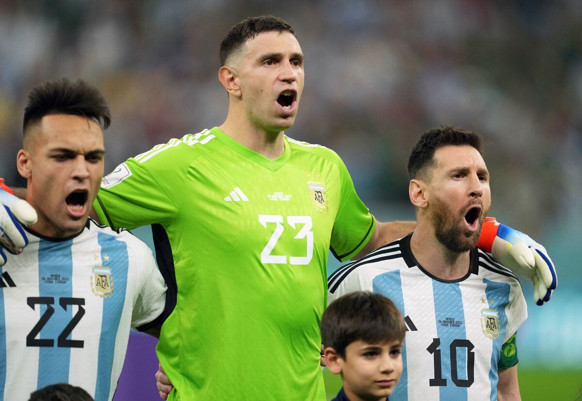               Argentina's Lionel Messi (right) singing the Argentinaian national anthem with Emiliano (centre) Martinez and Lautaro Martine