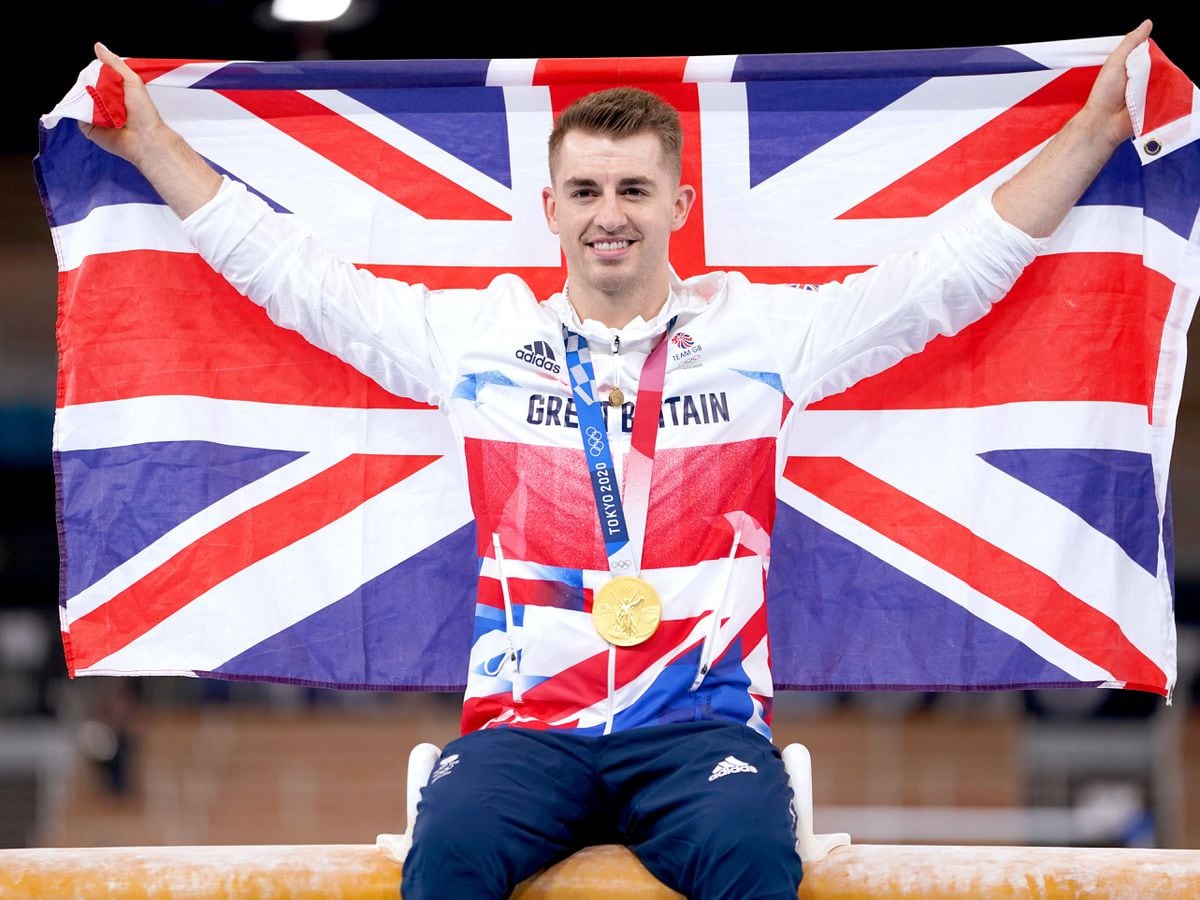 Great Britainâs Max Whitlock celebrates with his gold medal