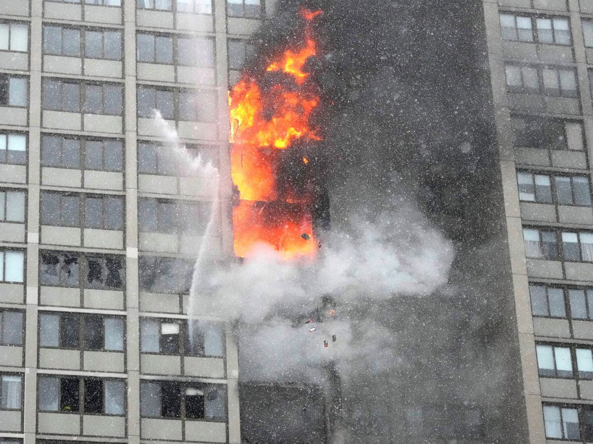 Flames leap skyward out of the Harper Square co-operative residential building in the Kenwood neighbourhood of Chicago