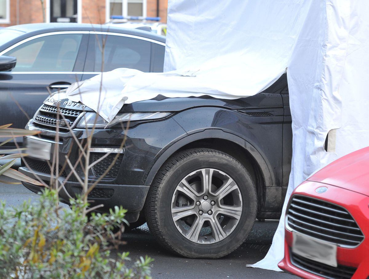 A police tent covering a Range Rover at the scene on Sunday morning