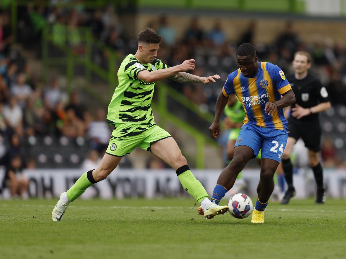 Christian Saydee of Shrewsbury Town and Oliver Casey of Forest Green Rovers.