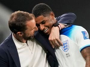 England's Marcus Rashford, right, is greeted by England's head coach Gareth Southgate as he leaves the pitch during the World Cup group B soccer match between England and Wales, at the Ahmad Bin Ali Stadium in Al Rayyan , Qatar, Tuesday, Nov. 29, 2022. (AP Photo/Frank Augstein).