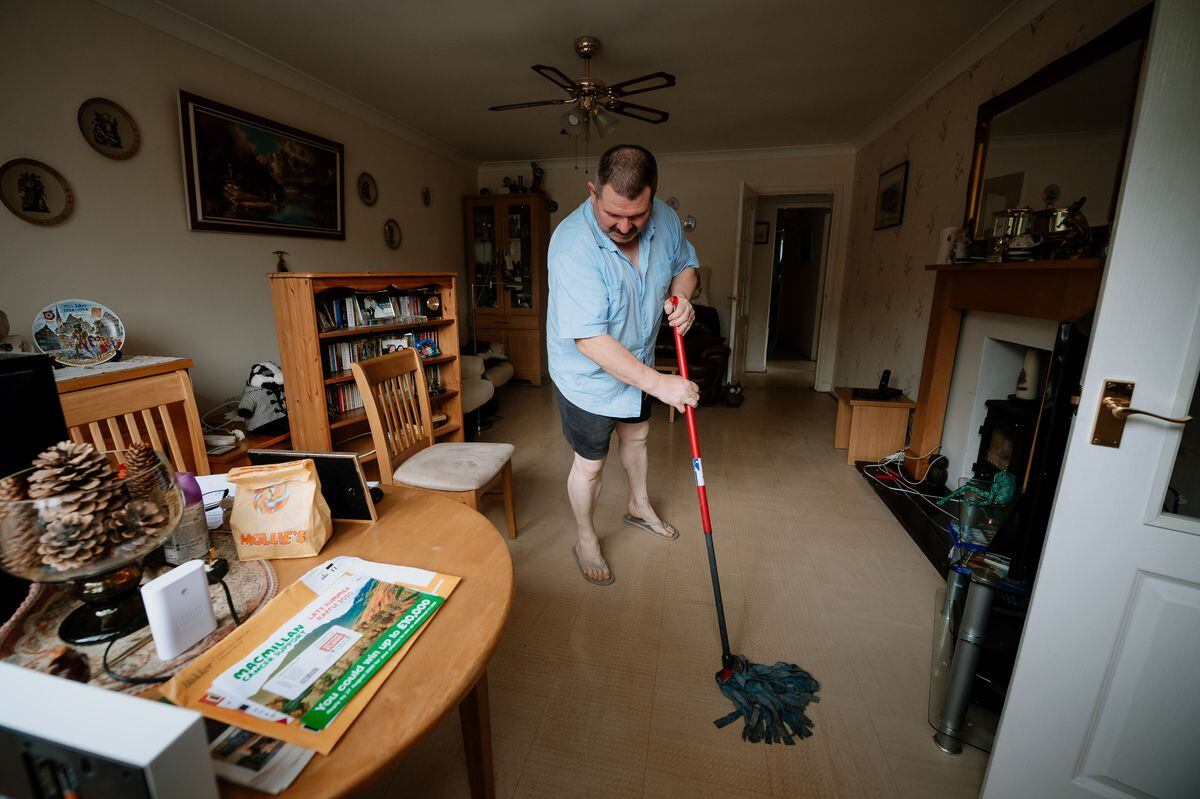 Stephen Watson cleans up over in Waterloo Road, Ketley, where homes were flooded