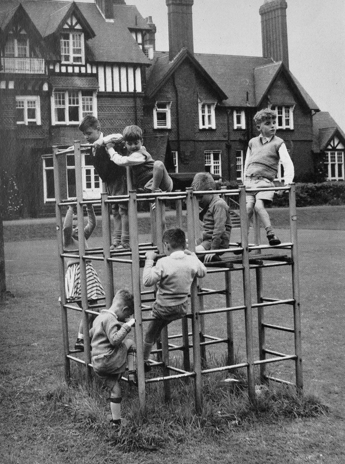 Children get to grips with a climbing frame in the grounds.