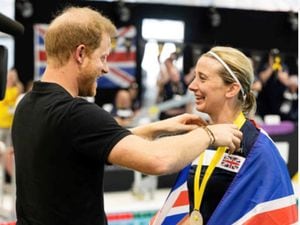 Kelly being presented with one of her silver medals by Prince Harry.