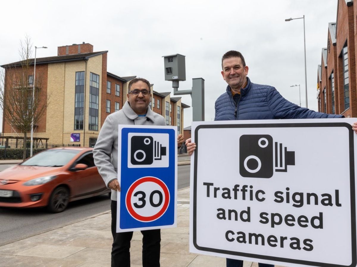 Councillor Raj Mehta and councillor Paul Watling in front of the speed camera in West Centre Way, Lawley
