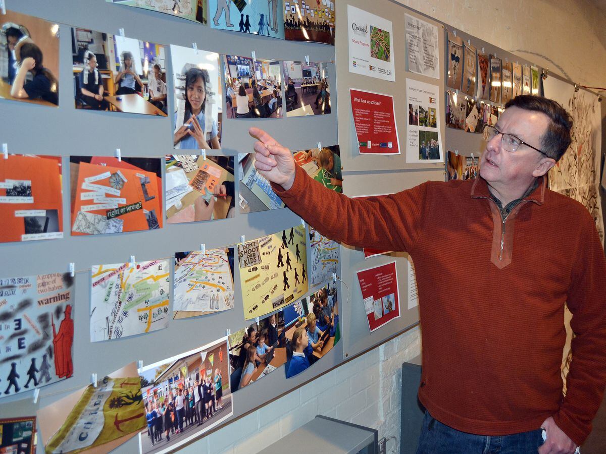 Pete Jackson, who chairs the Cinderloo 1821 group, looks at work by school children which forms part of the Cinderloo exhibition.
