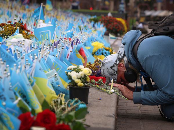 A person reacts during the All-National minute of silence in commemoration of Ukrainian soldiers killed in the country’s war against Russia