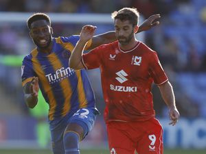 Chey Dunkley of Shrewsbury Town and Will Grigg of Milton Keynes Dons.