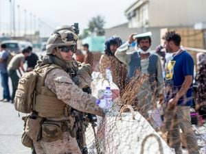 Marines with Special Purpose Marine Air-Ground Task Force-Crisis Response-Central Command (SPMAGTF-CR-CC) provide assistance during an evacuation at Hamid Karzai International Airport in Kabul, Afghanistan. 