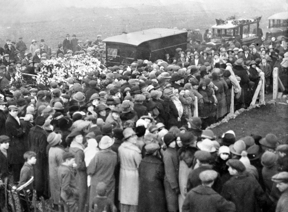 A crowd gathers outside the Willits' home on the Old Heath housing estate as the cortege prepares to leave.