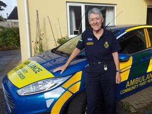 Effie Cadwallader with the car from her days volunteering with the West Midlands Ambulance Service 