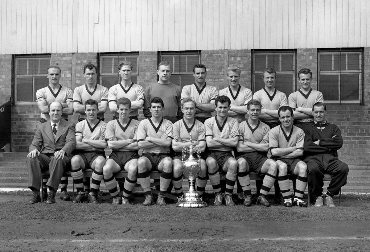 Wolverhampton Wanderers who retained their Football League First Division Championship with 61 points from 42 games. Pictured with the trophy are. (back row l-r) Gwyn Jones, Eddie Clamp, Bill Slater, Malcolm Finlayson, Edward Stuart, Ron Flowers, George Showell, John Harris. (front row l-r-) Stanley Cullis (manager), Michael Lill, Peter Broadbent, Colin Booth, Billy Wright, Jim Murray, Bobby Mason, Norman Deeley and Joe Gardiner (trainer).