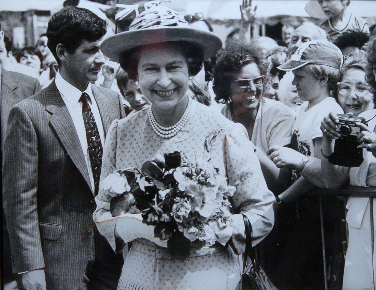 Hilda Tonks, of Bloxwich, pictured behind the Queen's left shoulder during her visit to Redditch in 1982