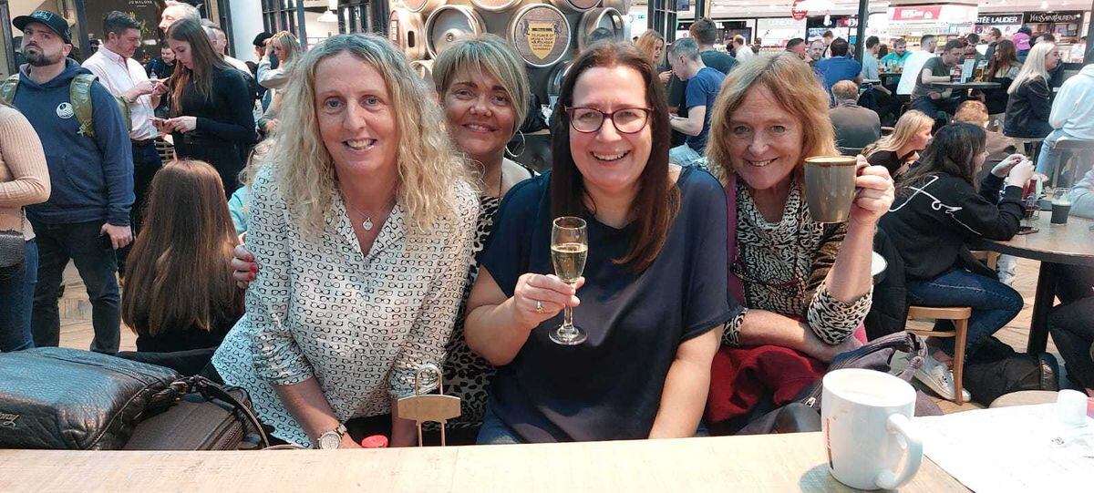 Maria Cusine, centre, with friends looking forward to their flight - before it was cancelled
