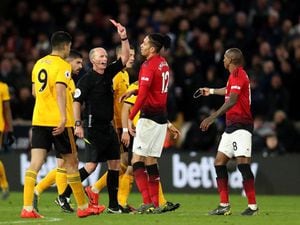 Match referee Mike Dean shows a red card and sends off Manchester United's Ashley Young during the Premier League match at Molineux Stadium, Wolverhampton