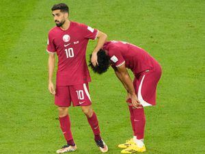 Qatar’s Hassan Al-Haydos (left) and Akram Afif (right) react after defeat to Senegal
