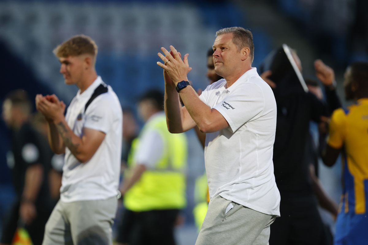 Steve Cotterill the head coach / manager of Shrewsbury Town celebrates with his players at full time in front of the Shrewsbury Town supporters. (AMA)