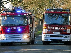 Fire crews tackle blaze at car workshop and stables on Shropshire border